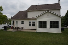 The season porch overlooks a patio and a nice flat lot.