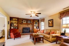 Family room with fireplace with built in bookshelves.